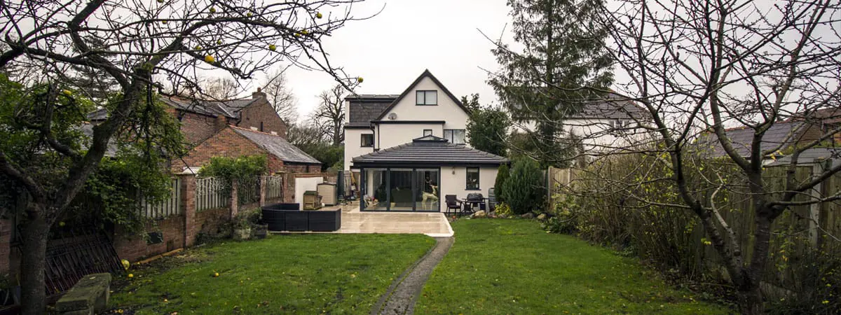 Aluminium installation in Cheshire featuring corner bifold doors, grey modern aluminium windows and matchign roof lantern.