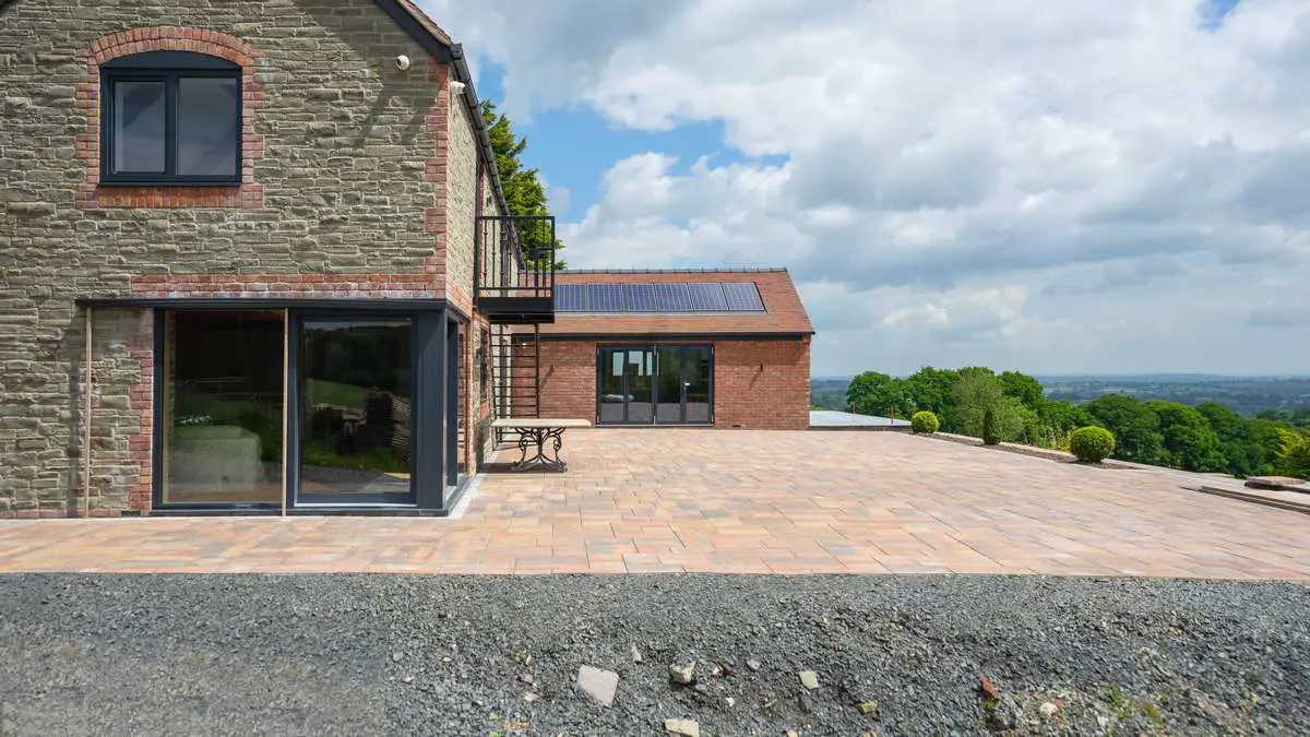 Side view of the rear of the property showing a large corner sliding door, bifold and Internorm window.