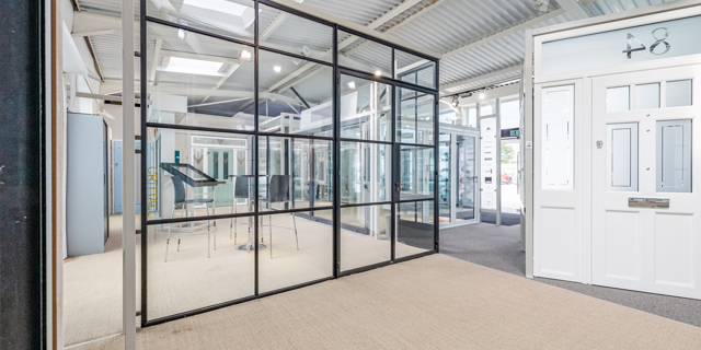 Large Crittall window and door in showroom facing seating area