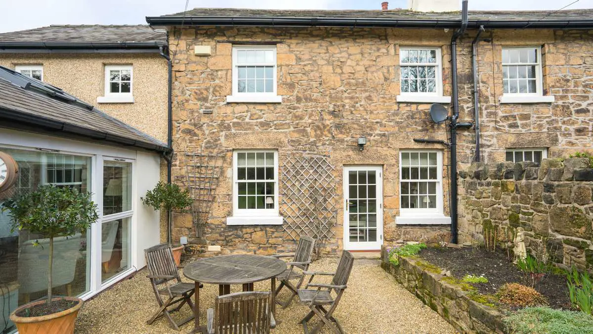 External view of timber window and door installation in period stone property.