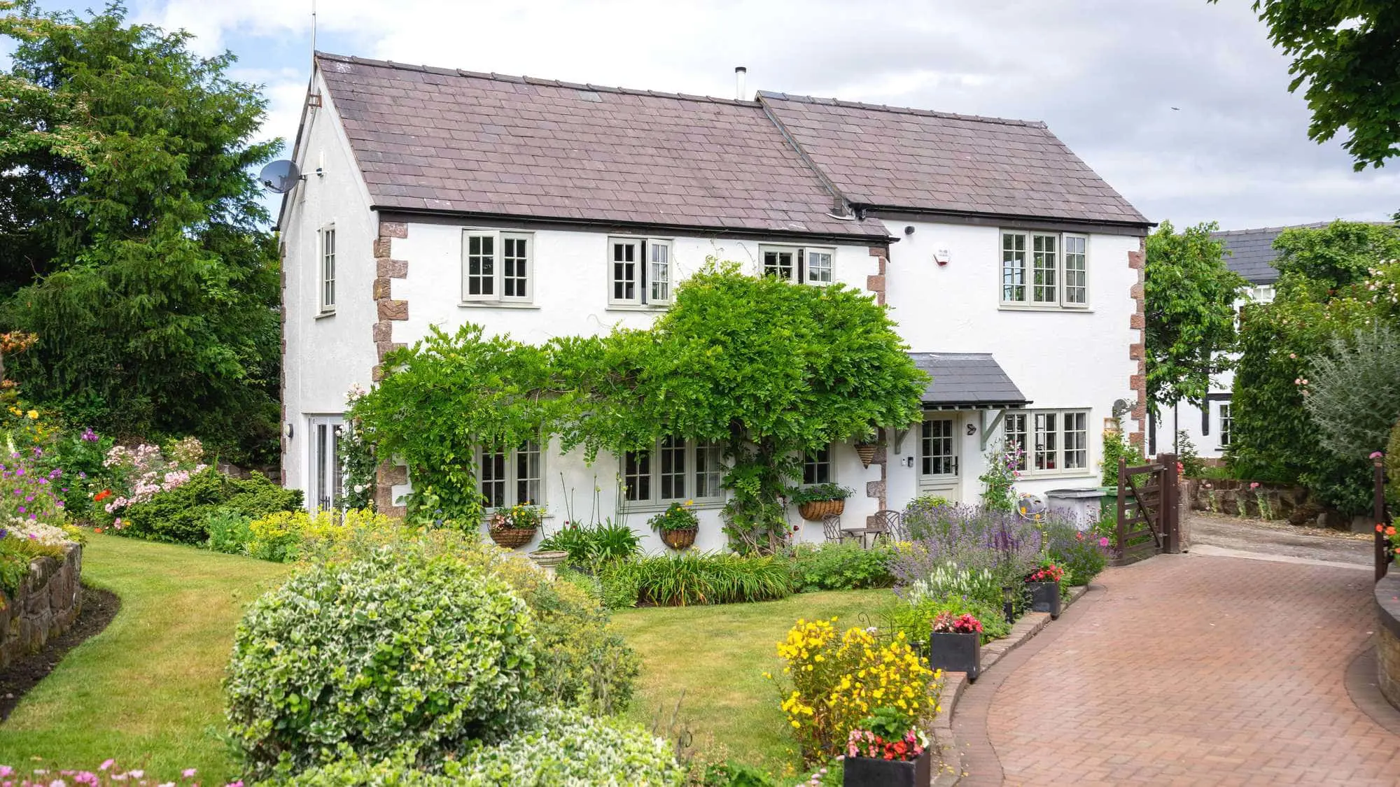 Traditional sandstone cottage featuring new timber alternative windows and doors.