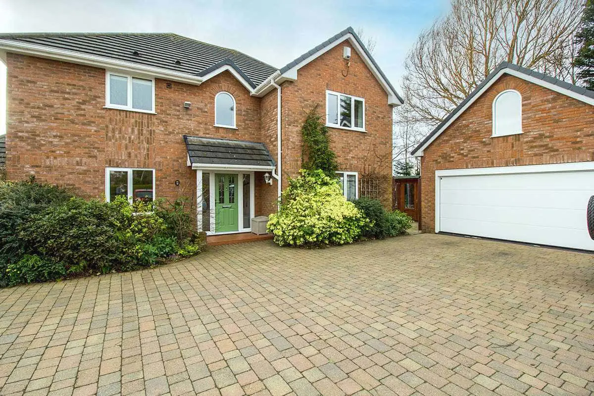 Full shot of house showing entrance door and UPVC windows installed throughout the house and garage.