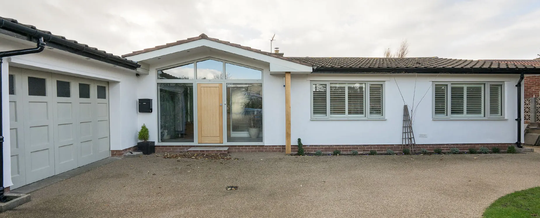 Pitched glazed aluminium entrance with oak door.