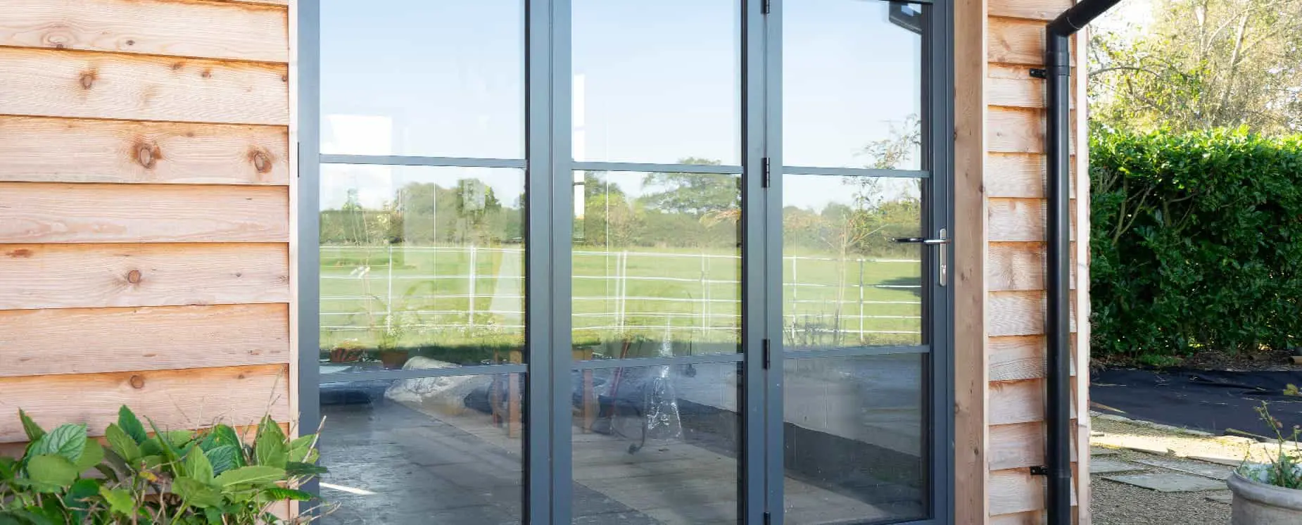 Steel alternative bifold doors in aluminium with horizontal glazing bars.