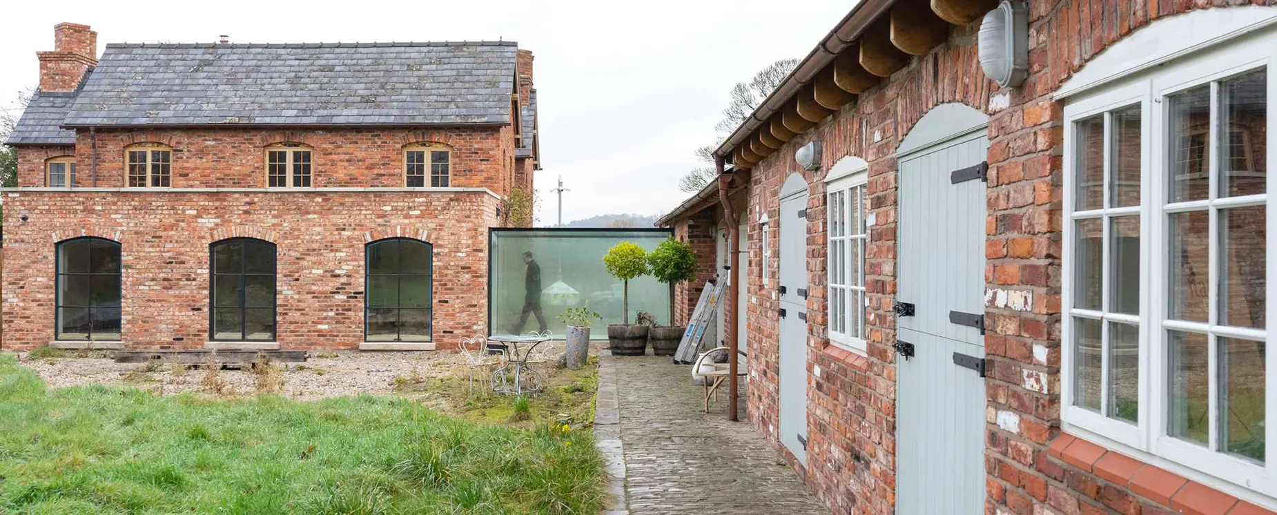 Glass link between buildings as part of a large property renovation in Cheshire