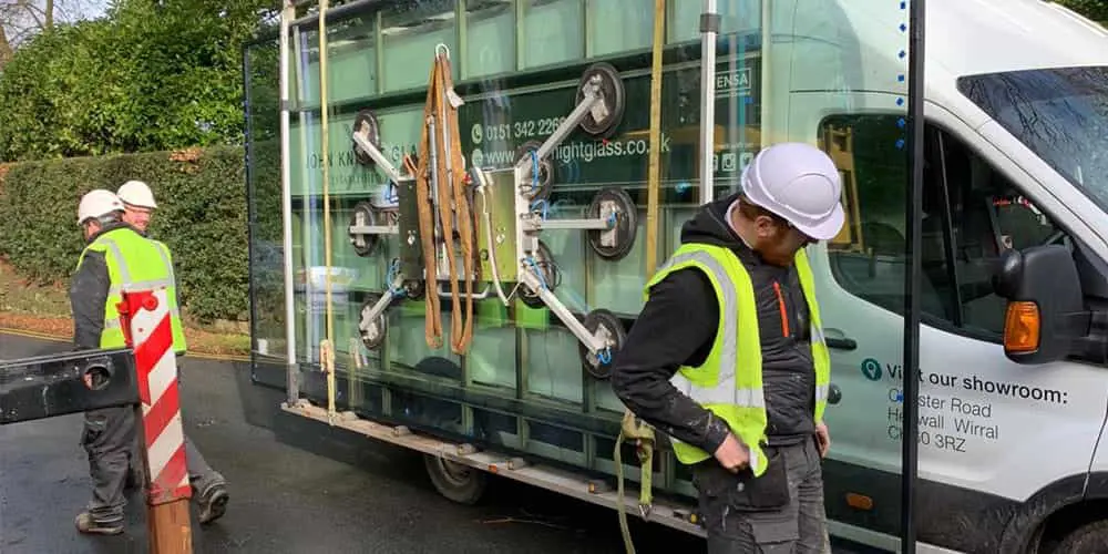 Window fitters with a van and glass on the side