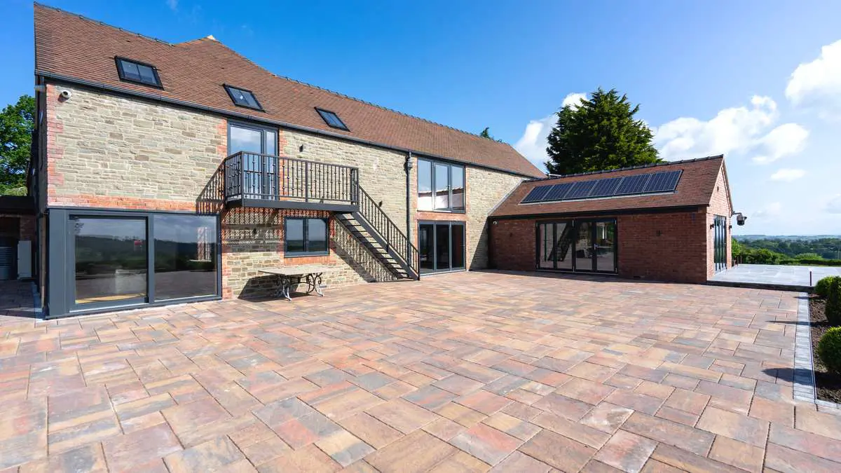 Main view of the rear of the property featuring a full glazing installation. .