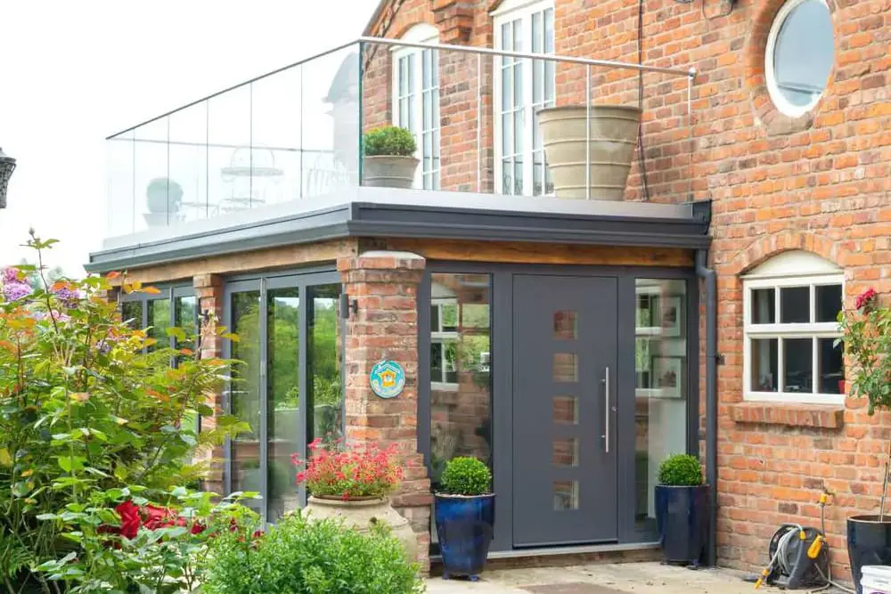 Traditional orangery with modern windows and entrance door.
