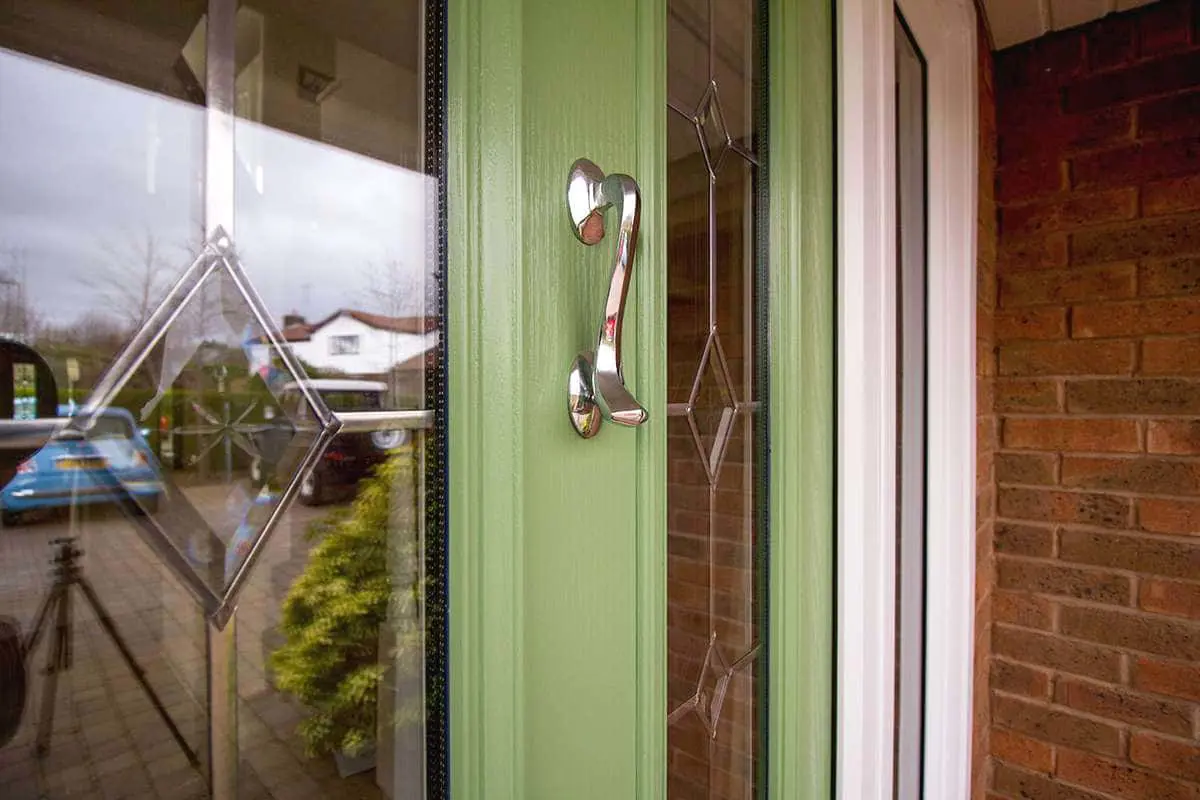 Close up of lead lights and chrome door knocker on the stunning composite entrance door.