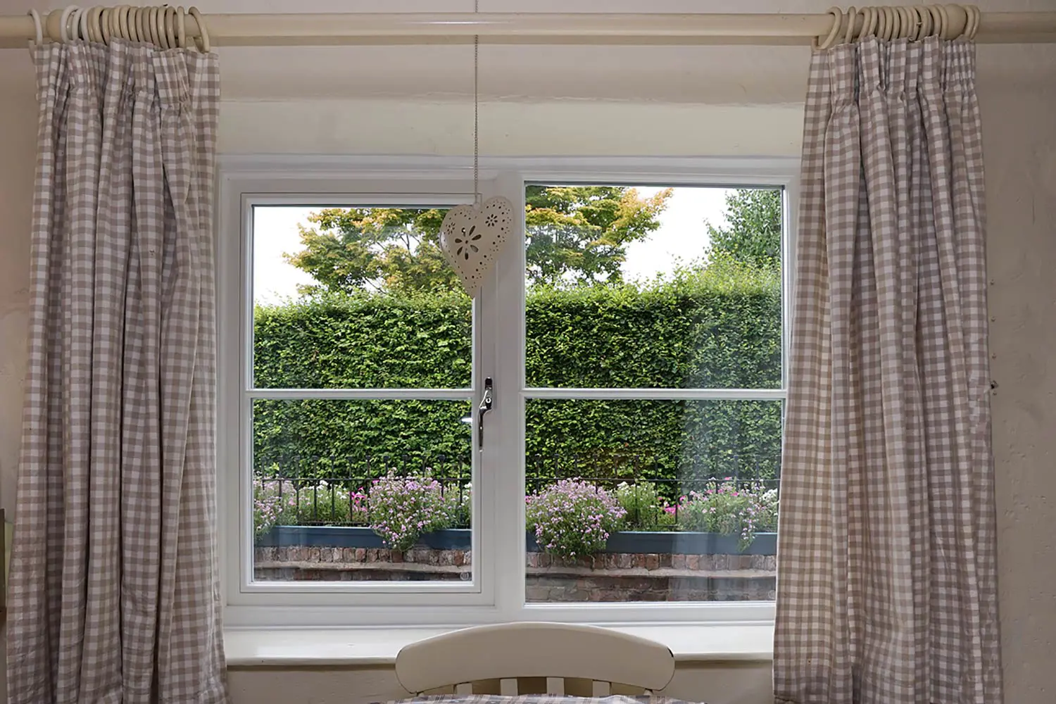 Internal shot of timber window showing traditional orate beading around the glazing and astregal bars.