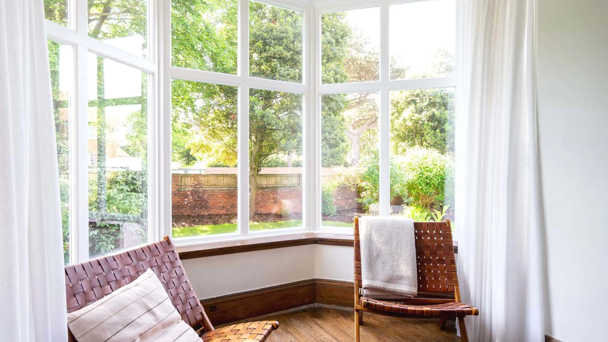 Close up of timber bay window completed in a painted white finish.