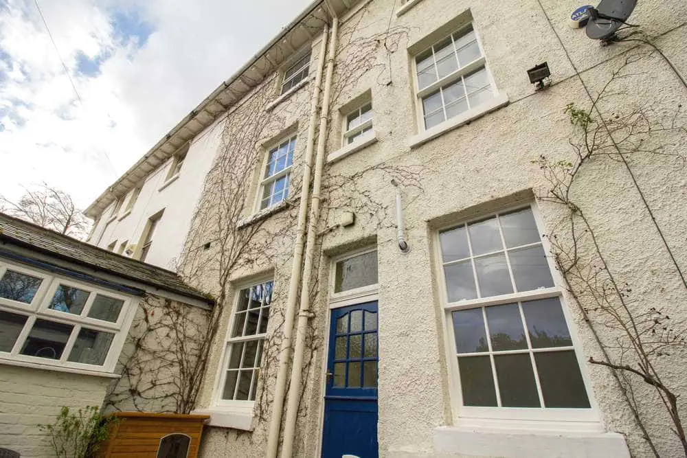 Rear view of property showing various smaller sash windows installed.