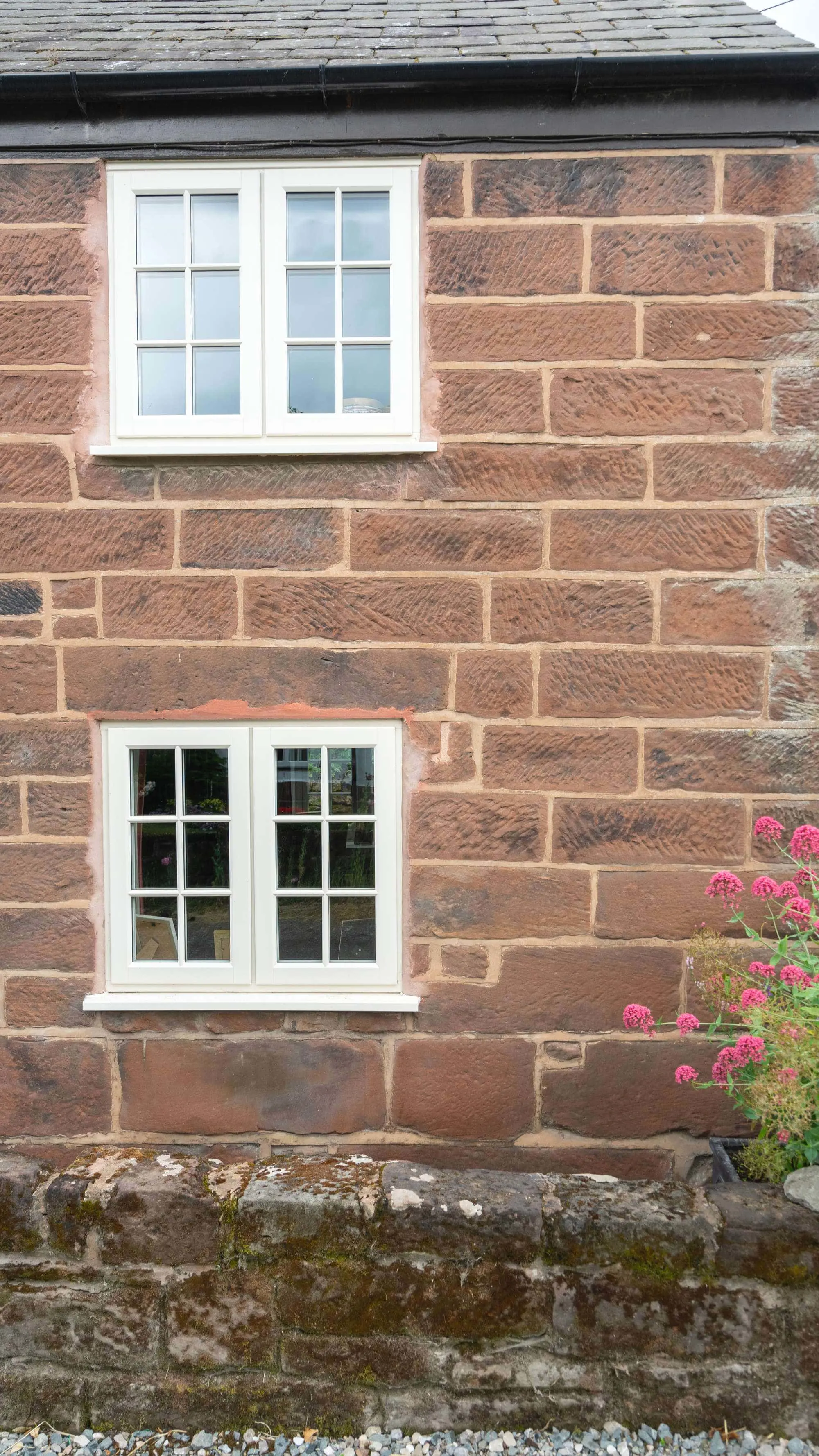 Upvc windows installed in sandstone building.