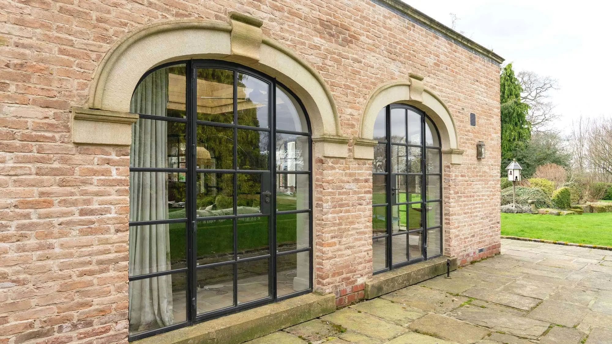Dual arched Crittall screens.