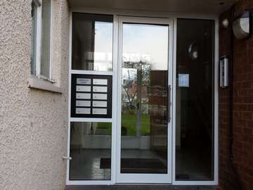 Commercial door entrance at Arrowepark Wirral . The doors were contructed from our Shopline range . Alpro handles . Double glazed with toughned glass / 8.8 laminated . Key pad opening anti fingure catch as standard