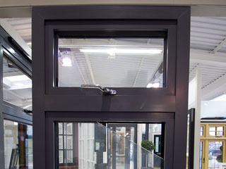 Full height view of Aluminium triple glazed window with chrome finish handles.